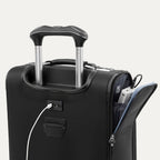 detail view of the shadow black travelpro platinum® elite carry-on spinner tote showing the external usb charging port with a cable plugged in, and the side pocket open to reveal a power bank stored inside.