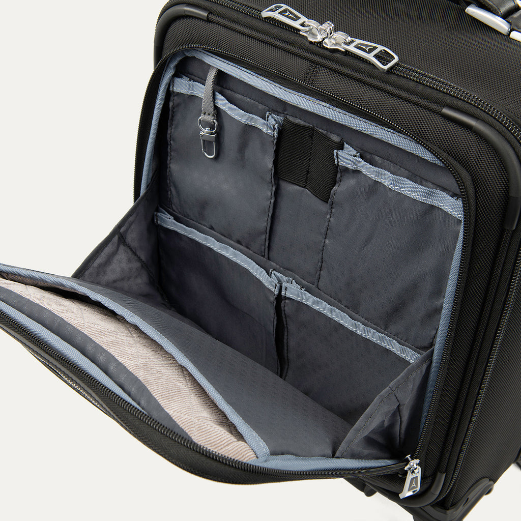 close-up interior view of the front organizer compartment on the shadow black travelpro platinum® elite carry-on spinner tote, showing multiple grey mesh slip pockets, a key leash, and organized storage for small travel essentials.