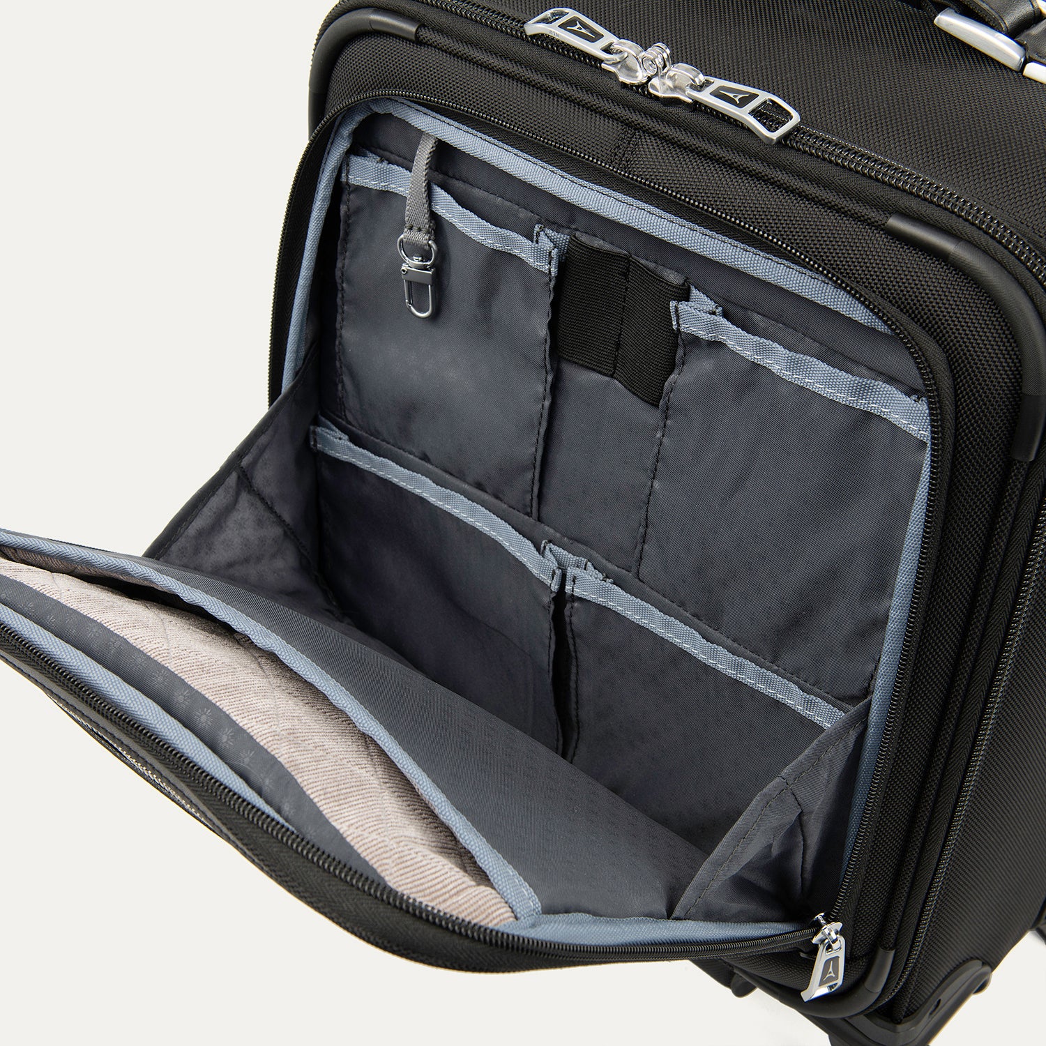close-up interior view of the front organizer compartment on the shadow black travelpro platinum® elite carry-on spinner tote, showing multiple grey mesh slip pockets, a key leash, and organized storage for small travel essentials.