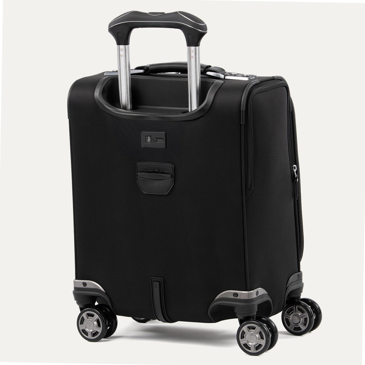 rear-angled view of the shadow black travelpro platinum® elite carry-on spinner tote, featuring the quick-access rear pocket, integrated trolley strap for stacking on luggage, and high-performance magnatrac® self-aligning spinner wheels.