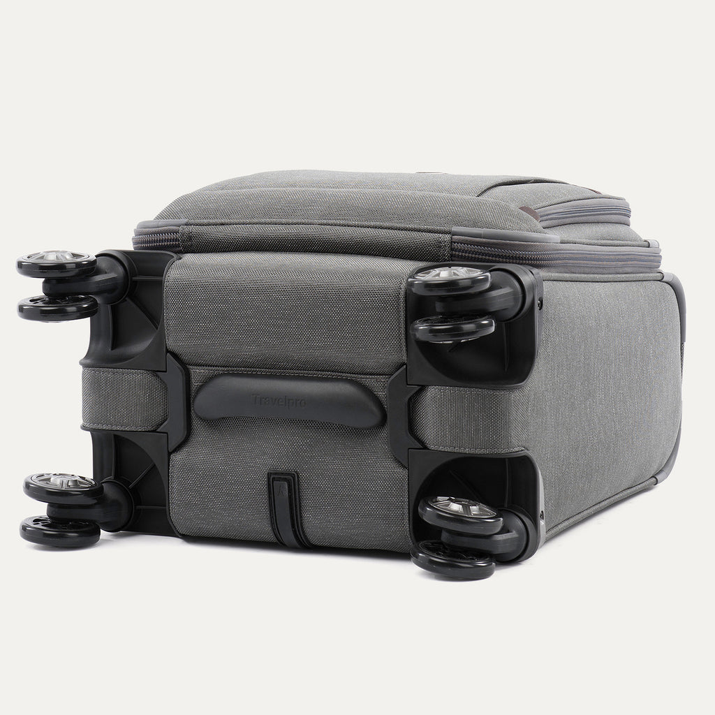 bottom view of the vintage grey travelpro platinum® elite carry-on spinner tote, showing the four high-performance magnatrac® self-aligning spinner wheels, the protective bottom molding with the travelpro logo, and the durable fabric base.