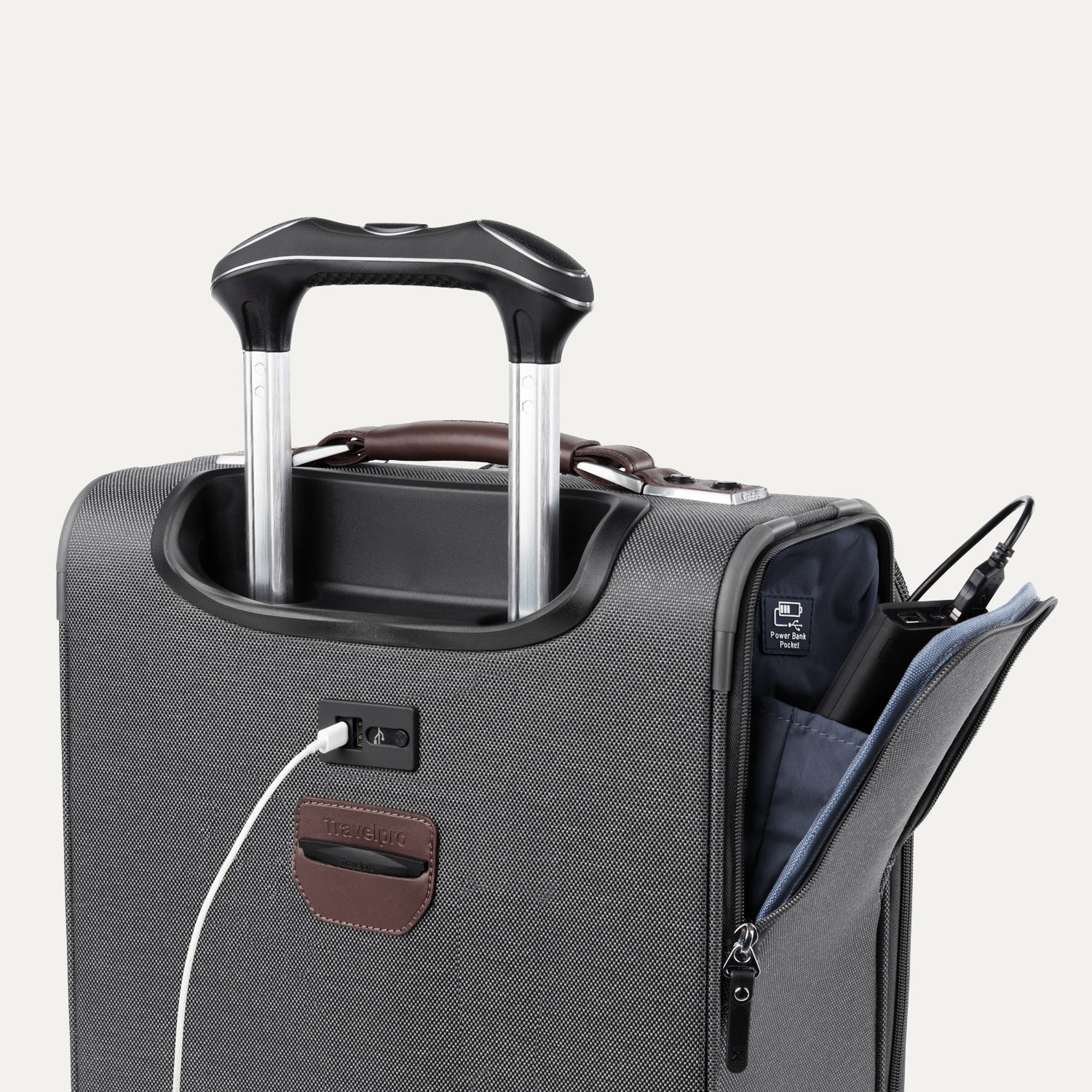 detail view of the vintage grey travelpro platinum elite carry-on spinner tote showing the external usb charging port with a cable plugged in, and the side pocket open to reveal the power bank pocket label and stored battery.
