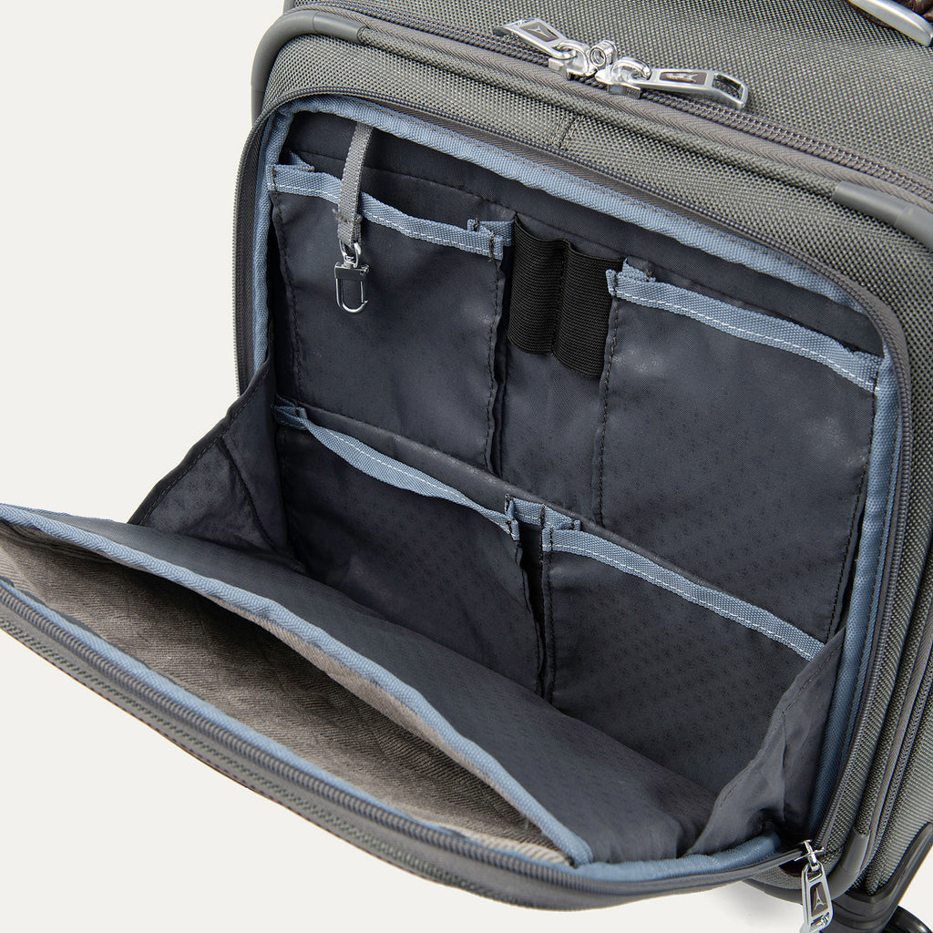 close-up interior view of the front organizer compartment on the vintage grey travelpro platinum® elite carry-on spinner tote, showing multiple grey mesh slip pockets, a key leash, and organized storage for small travel essentials.