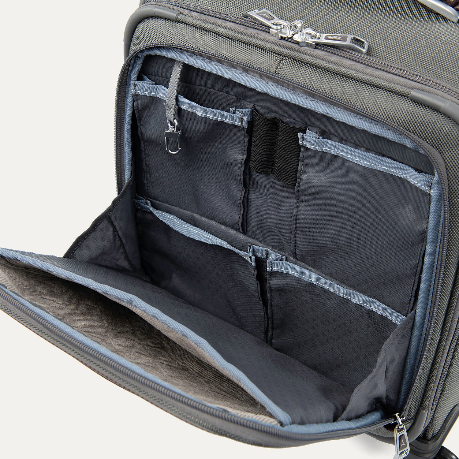 close-up interior view of the front organizer compartment on the vintage grey travelpro platinum® elite carry-on spinner tote, showing multiple grey mesh slip pockets, a key leash, and organized storage for small travel essentials.