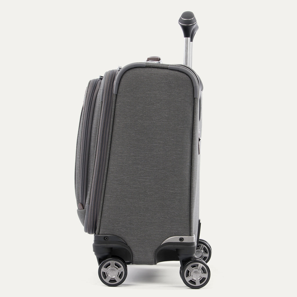 side profile view of the vintage grey travelpro platinum® elite carry-on spinner tote, showing the high-performance magnatrac® self-aligning spinner wheels and the extended airline-grade powerscope extension handle.