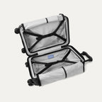 Interior packing view of the Travelpro Platinum Elite Compact Carry-On Hardside Spinner in Aviator Navy, showing the organized compartment with adjustable hold-down straps and the signature ECOFAB™ lining.