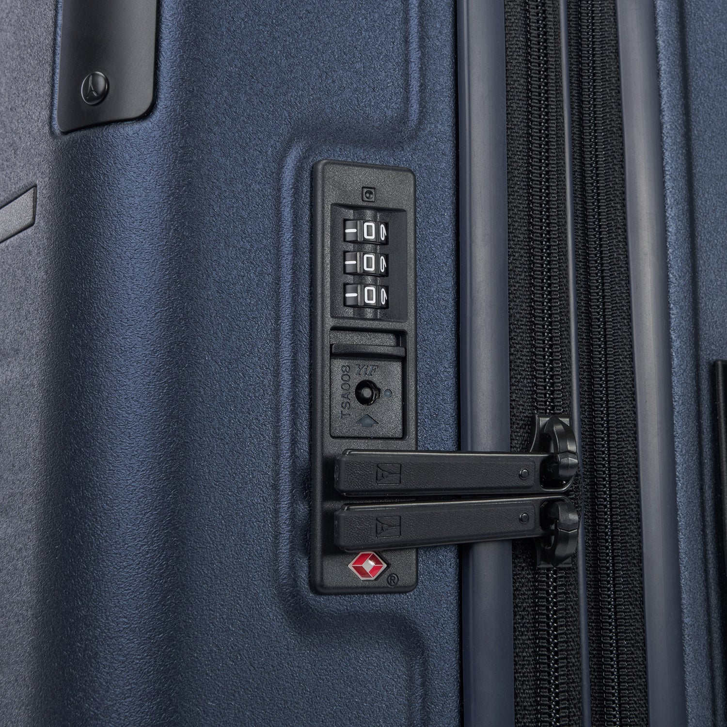 close-up of the integrated tsa-approved combination lock on the travelpro platinum elite compact carry-on hardside spinner in aviator navy, featuring secure zipper pulls locked into the dial mechanism.