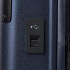 macro detail view of the external usb-a and usb-c charging ports on the travelpro platinum elite compact carry-on hardside spinner in aviator navy, highlighting the integrated power connectivity.