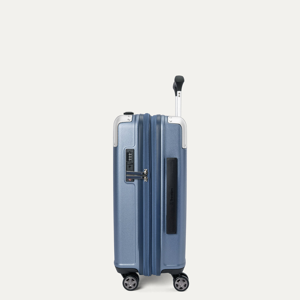 side profile view of the travelpro platinum elite compact carry-on hardside spinner in dark sky blue, showcasing the slim design, integrated tsa lock, and the 2-inch expansion gusset.
