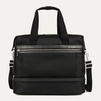 front view of the black travelpro platinum elite drop-bottom weekender bag, featuring its signature two-compartment design with premium black leather trim, chrome hardware, and a removable shoulder strap.
