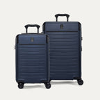 Front view of the Travelpro Platinum Elite 2-Piece Hardside Spinner Set in Aviator Navy, featuring the Carry-On and Medium Check-In suitcases with 100% polycarbonate shells and genuine leather trim.
