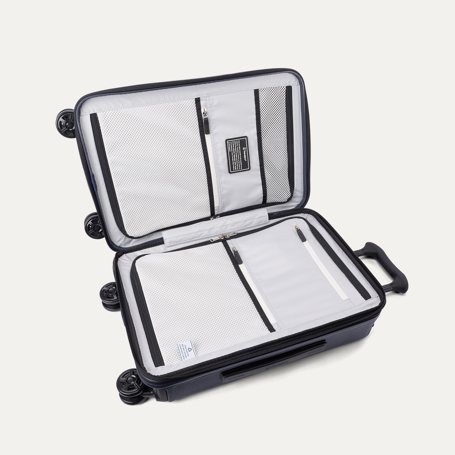 Interior packing view of the Travelpro Platinum Elite Carry-On Hardside Spinner in Aviator Navy, featuring dual zippered divider panels and the ECOFAB™ lining made from 100% recycled plastic bottles.