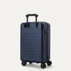 Rear 3/4 view of the Travelpro Platinum Elite Carry-On Hardside Spinner in Aviator Navy, featuring the adjustable PowerScope Lite handle and high-performance, self-aligning spinner wheels.