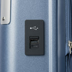 Macro detail view of the external USB-A and USB-C charging ports on the Travelpro Platinum Elite Carry-On Hardside Spinner in Dark Sky Blue, highlighting the integrated power connectivity for mobile devices.