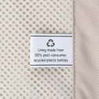 Close-up detail of the ECOFAB™ lining inside the Travelpro Platinum Elite Carry-On Hardside Spinner in Dark Sky Blue, showing a white fabric label that reads "Lining made from 100% post-consumer recycled plastic bottles" with a green recycling symbol.