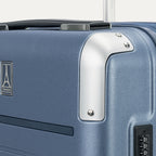Close-up detail of the Travelpro Platinum Elite Carry-On Hardside Spinner in Dark Sky Blue, showing the protective polished aluminum corner armor and the integrated TSA-approved combination lock.