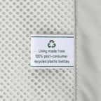 Close-up detail of the ECOFAB™ lining inside the Travelpro Platinum Elite Carry-On Hardside Spinner in Jet Black, showing a white fabric label that reads "Lining made from 100% post-consumer recycled plastic bottles" with a green recycling symbol.