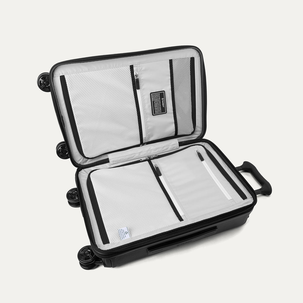 Interior packing view of the Travelpro Platinum Elite Carry-On Hardside Spinner in Jet Black, featuring dual zippered divider panels and adjustable hold-down straps for organized travel.