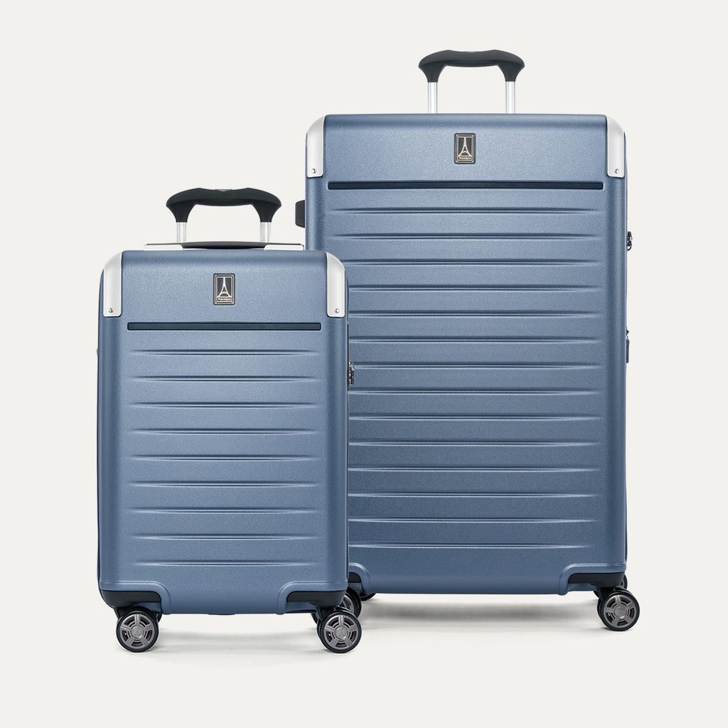 Front view of the 2-piece Travelpro Platinum Elite Hardside Set in Dark Sky Blue, featuring the Compact Carry-On and large Check-In Expandable Spinners with durable polycarbonate shells and aluminum corner guards.