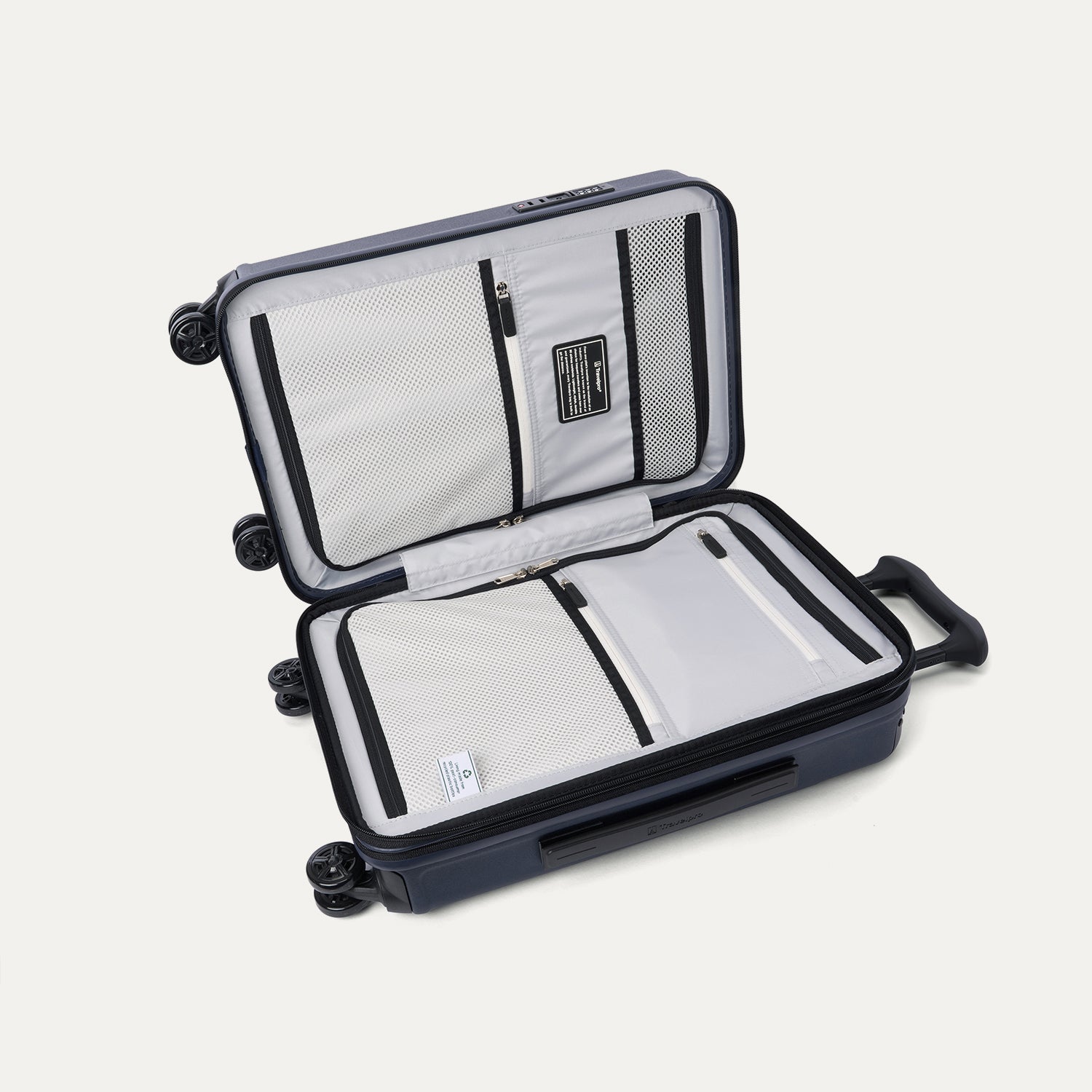 Interior view of the open Travelpro Platinum Elite Compact Carry-On Hardside Spinner in Aviator Navy, featuring dual zippered divider panels and a dedicated internal pocket for FAA-compliant battery storage.