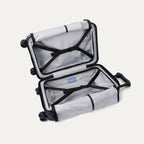 Interior view of the open Travelpro Platinum Elite Compact Carry-On Hardside Spinner in Aviator Navy, featuring dual zippered divider panels and a dedicated internal battery pocket for power bank storage.