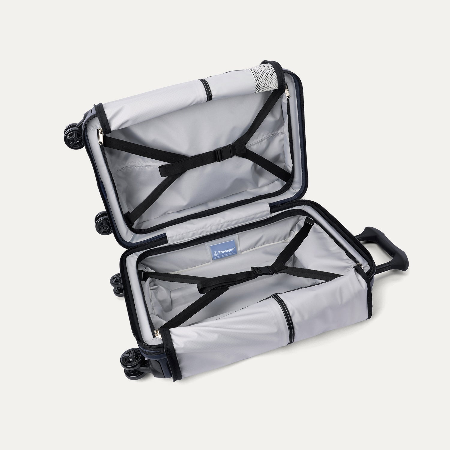 Interior view of the open Travelpro Platinum Elite Compact Carry-On Hardside Spinner in Aviator Navy, featuring dual zippered divider panels and a dedicated internal battery pocket for power bank storage.