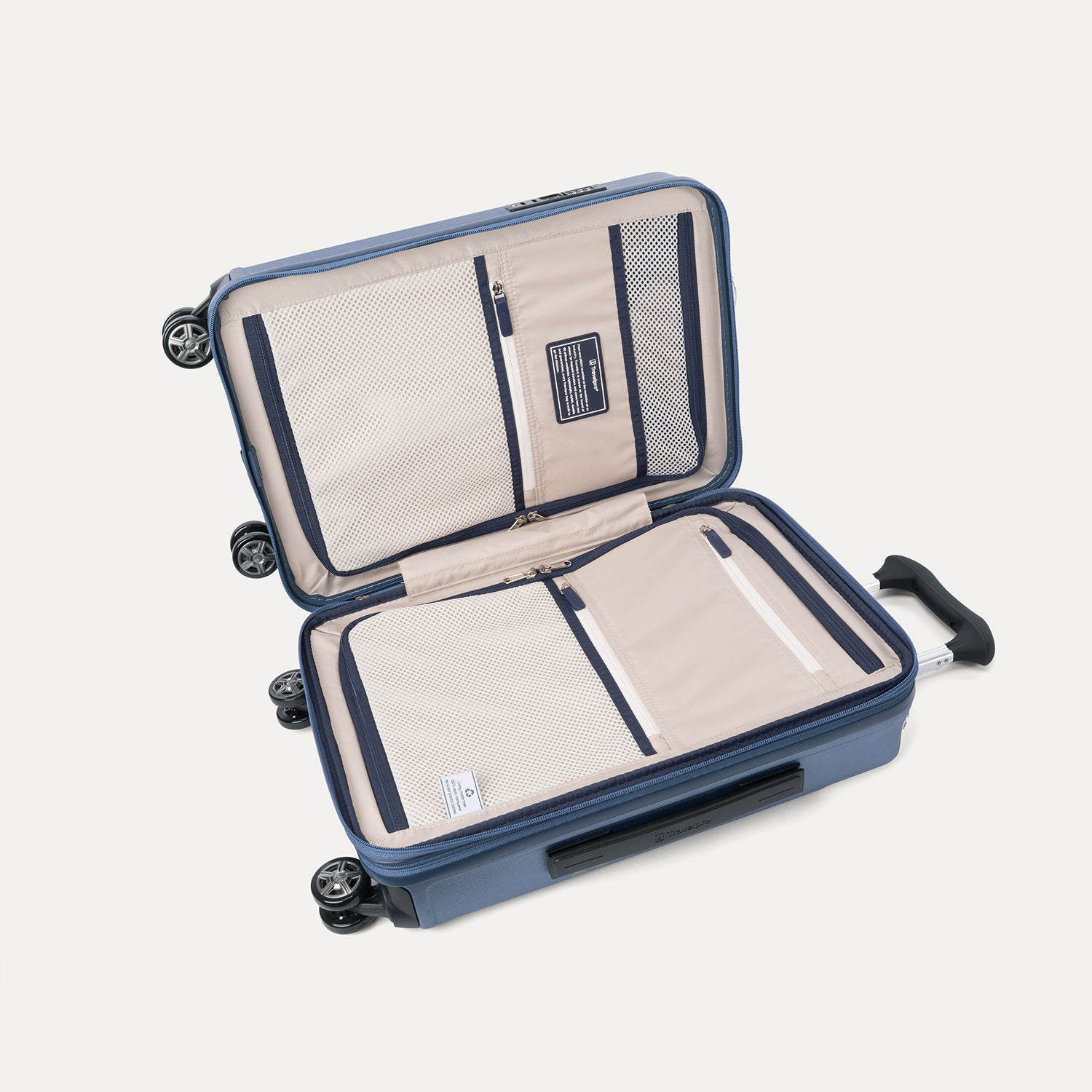 Interior packing compartments of the Travelpro Platinum Elite Compact Carry-On Hardside Spinner in Dark Sky Blue, featuring a zippered divider panel and integrated battery pocket for on-the-go charging.