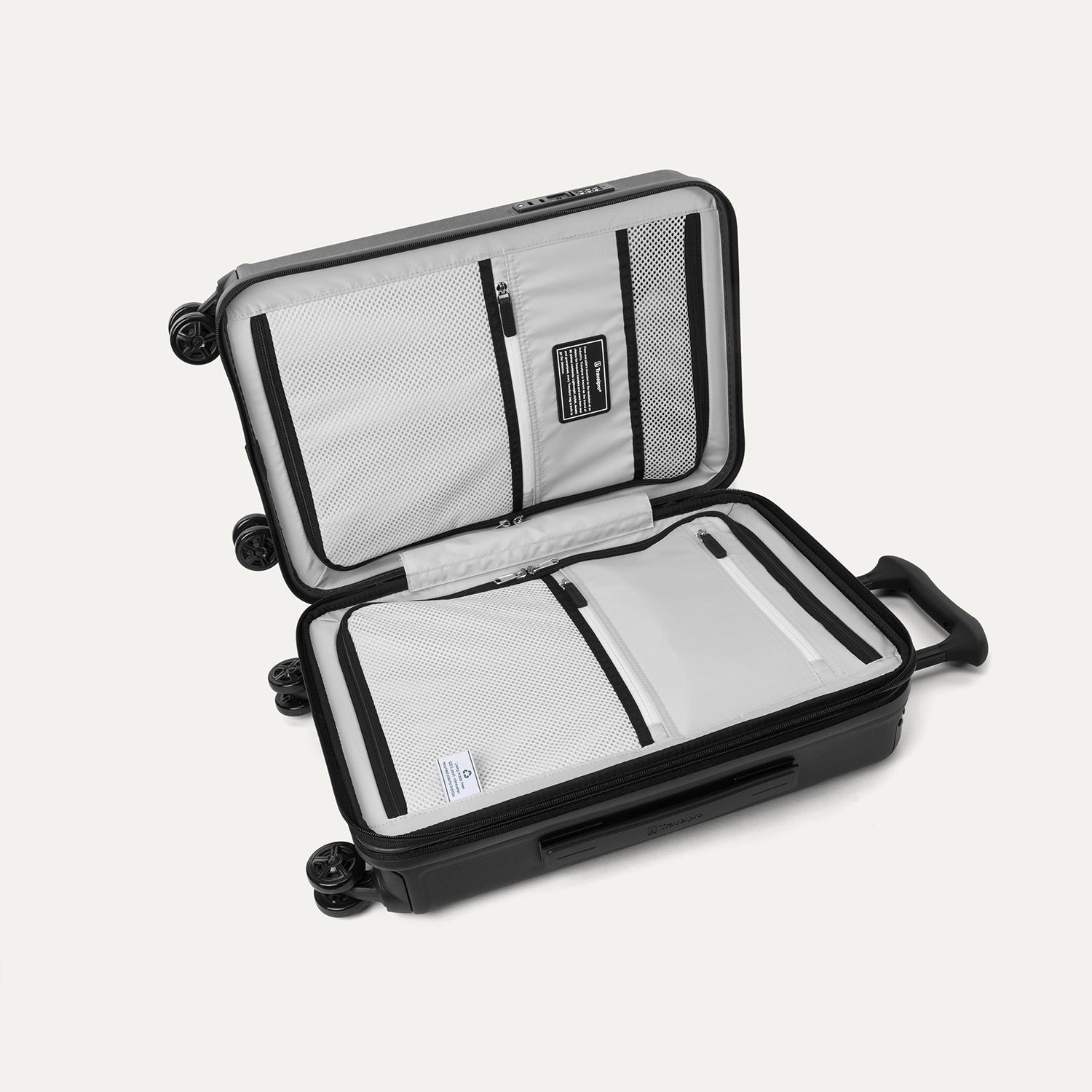 Interior view of the Travelpro Platinum Elite Compact Carry-On Hardside Spinner in Jet Black, featuring dual zippered divider panels and a dedicated internal battery pocket for power bank storage.