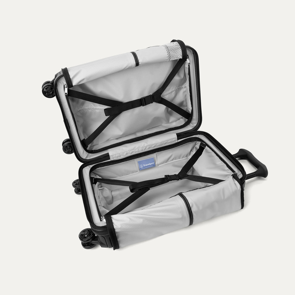Full interior view of the open Travelpro Platinum Elite Compact Carry-On Hardside Spinner in Jet Black, featuring adjustable hold-down straps and a large zippered mesh organizer pocket.