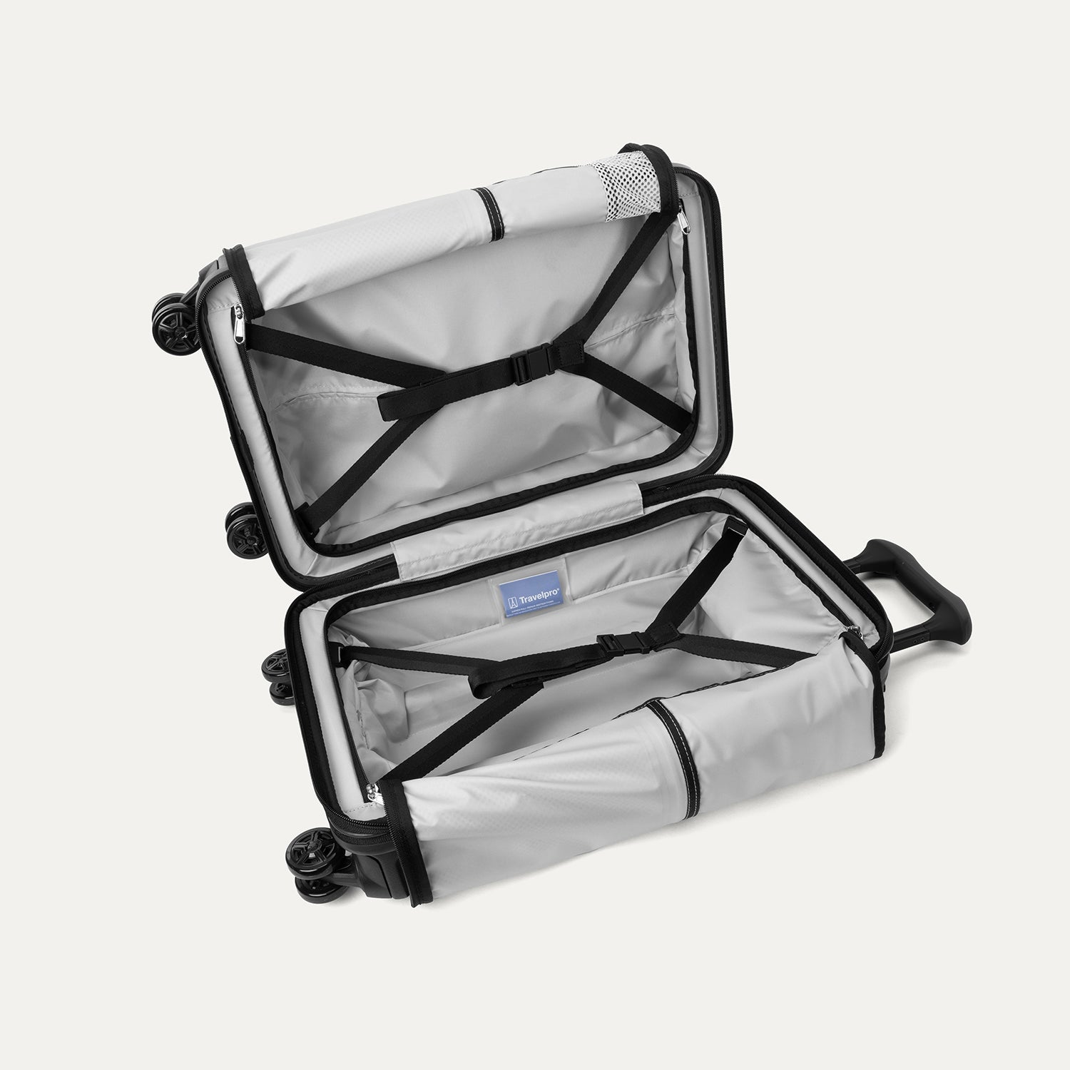 Full interior view of the open Travelpro Platinum Elite Compact Carry-On Hardside Spinner in Jet Black, featuring adjustable hold-down straps and a large zippered mesh organizer pocket.