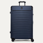 Front view of the Travelpro Platinum Elite Large Check-In Hardside Spinner in Aviator Navy, featuring a high-durability 100% polycarbonate shell, aluminum corner guards, and 360-degree MagnaTrac self-aligning spinner wheels.