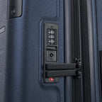 Close-up detail of the Travelpro Platinum Elite Large Check-In Hardside Spinner in Aviator Navy, highlighting the integrated TSA-approved combination lock and zipper pulls for secure travel.