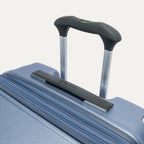 Close-up of the Travelpro Platinum Elite Large Check-In Hardside Spinner in Dark Sky Blue, featuring the multi-stop PowerScope Lite handle and ergonomic rubberized Contour Grip for comfortable handling.