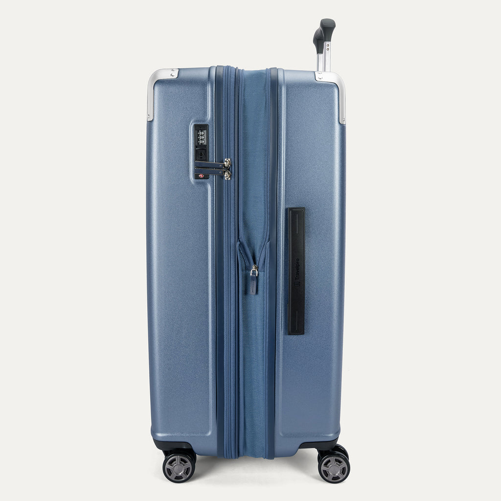 Side profile view of the Travelpro Platinum Elite Large Check-In Hardside Spinner in Dark Sky Blue, showing the expansion zipper, integrated TSA-approved lock, and side carry handle.