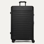 Front view of the Travelpro Platinum Elite Large Check-In Hardside Spinner in Jet Black, featuring a durable polycarbonate shell, aluminum corner armor, and genuine leather trim.