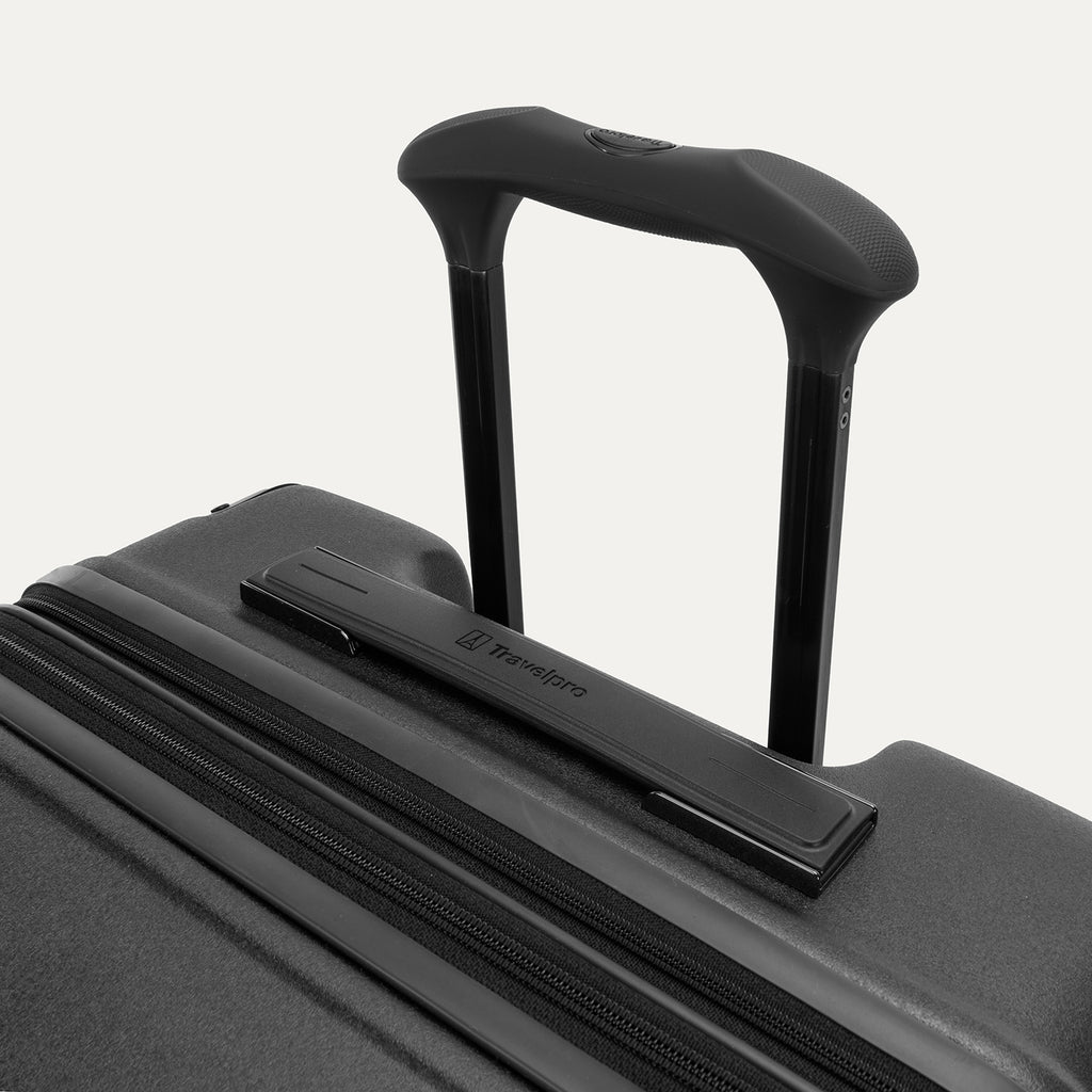 Close-up of the Travelpro Platinum Elite Large Check-In Hardside Spinner in Jet Black, featuring the sturdy PowerScope Lite handle with a comfortable, rubberized Contour Grip.