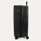 Side profile view of the Travelpro Platinum Elite Large Check-In Hardside Spinner in Jet Black, showing the expansion zipper, TSA-approved lock, and side carry handle.