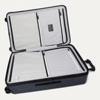 Interior view of the open Travelpro Platinum Elite large Check-In Hardside Spinner in Aviator Navy, featuring dual zippered divider panels, ECOFAB recycled lining, and spacious dual packing compartments.