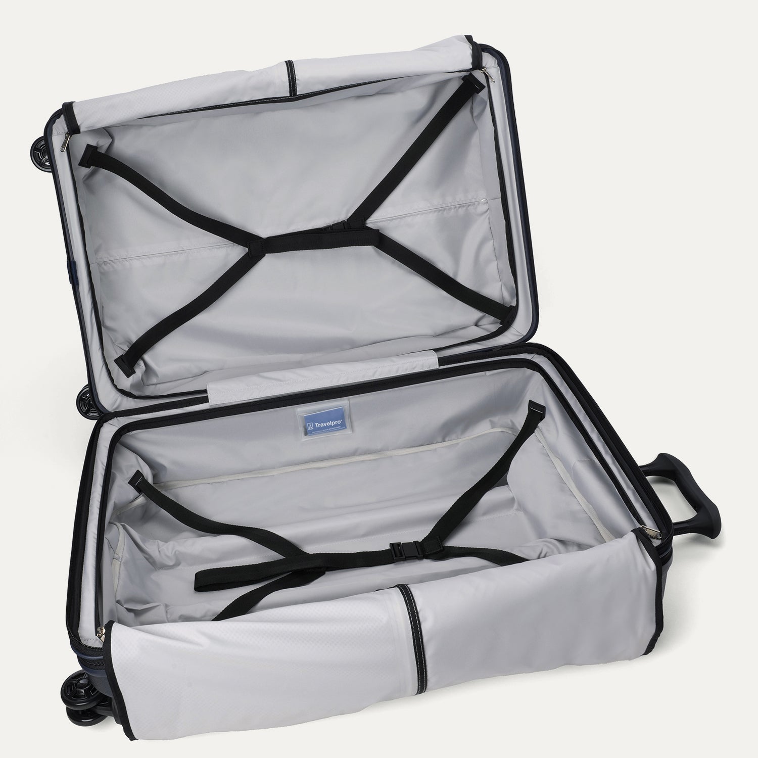 Interior packing view of the open Travelpro Platinum Elite large Check-In Hardside Spinner in Aviator Navy, featuring dual zippered divider panels, adjustable hold-down straps, and ECOFAB recycled lining.