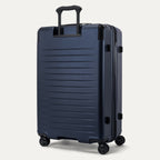 Rear 3/4 view of the Travelpro Platinum Elite Large Check-In Hardside Spinner in Aviator Navy, showing the PowerScope Lite aluminum handle and the durable 100% polycarbonate shell without branding.