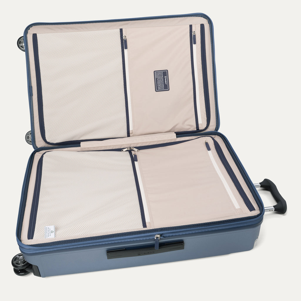 Internal organizational view of the Travelpro Platinum Elite large Check-In Hardside Spinner in Dark Sky Blue, featuring dual zippered divider panels and ECOFAB recycled lining.