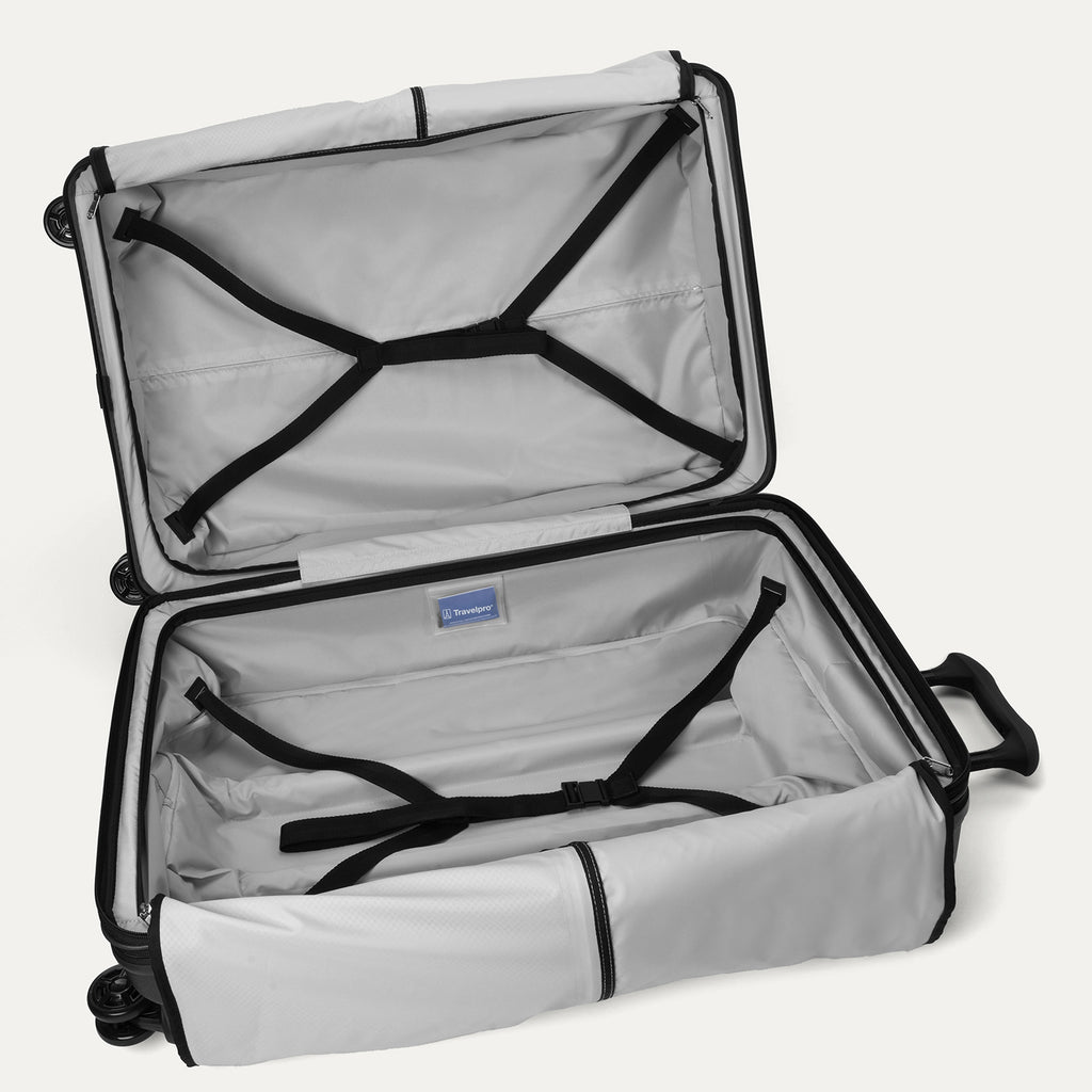 Open interior view of the empty Travelpro Platinum Elite Large Check-In Hardside Spinner in Jet Black, showcasing the spacious dual packing compartments, premium interior lining, and integrated compression straps.