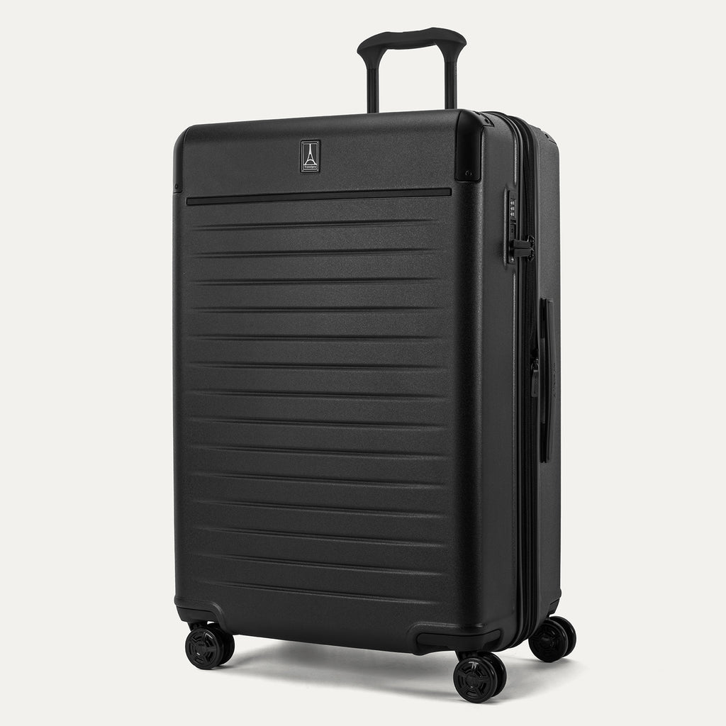 Front 3/4 view of the Travelpro Platinum Elite Large Check-In Hardside Spinner in Jet Black, featuring a 100% polycarbonate shell, aluminum corner armor, and integrated TSA-approved lock.