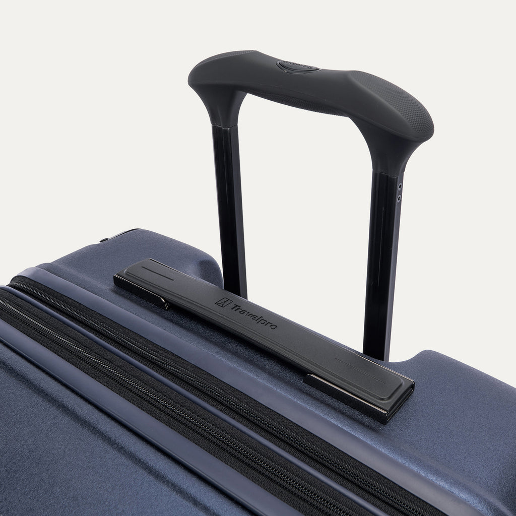 Close-up of the Travelpro Platinum Elite Medium Check-In Hardside Spinner in Aviator Navy, featuring the multi-stop PowerScope Lite handle and the sleek, low-profile top carry handle with the Travelpro logo.