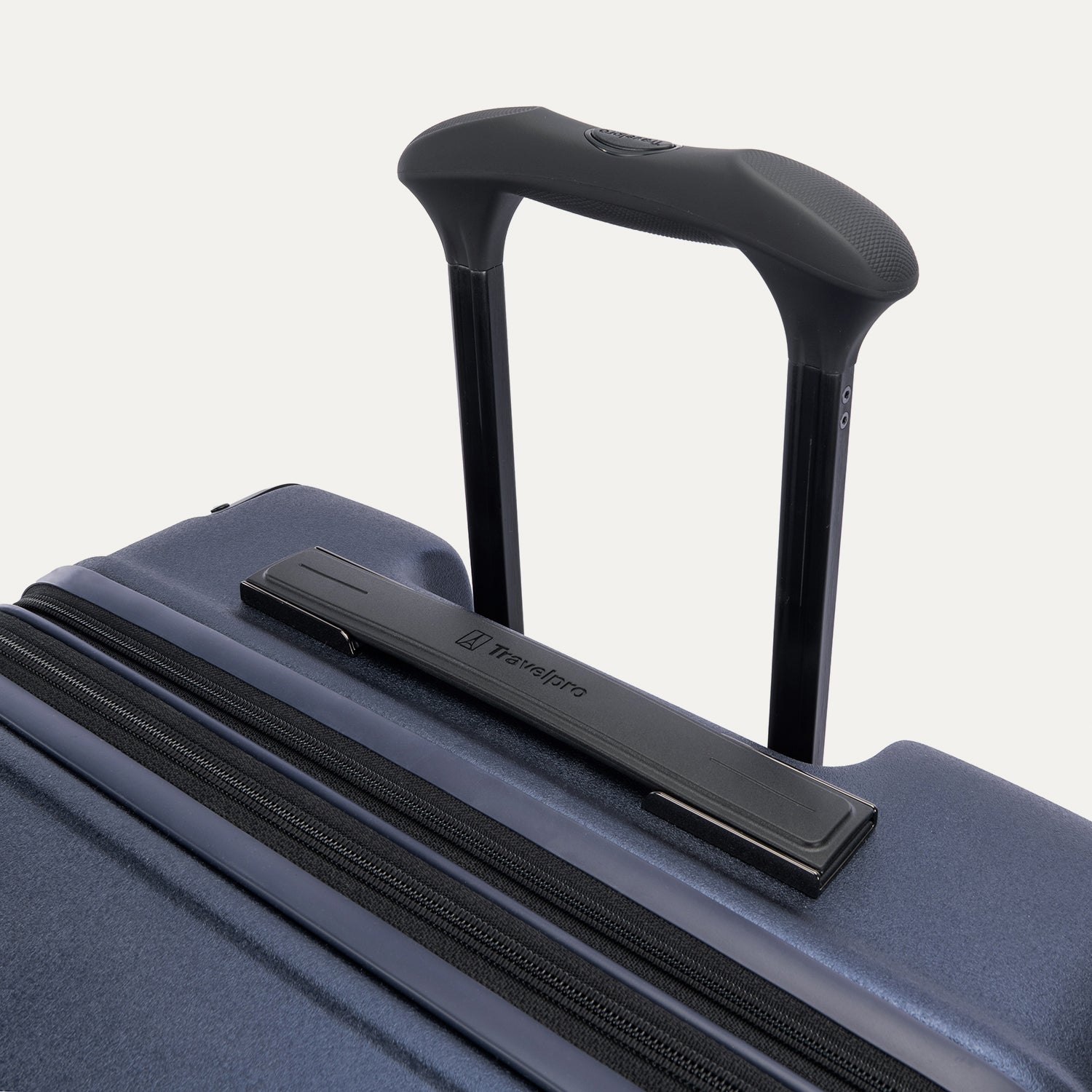 Close-up of the Travelpro Platinum Elite Medium Check-In Hardside Spinner in Aviator Navy, featuring the multi-stop PowerScope Lite handle and the sleek, low-profile top carry handle with the Travelpro logo.