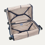 Interior view of the Travelpro Platinum Elite Medium Check-In Hardside Spinner in Dark Sky Blue, showing the adjustable hold-down straps and the spacious main compartment with ECOFAB™ lining.