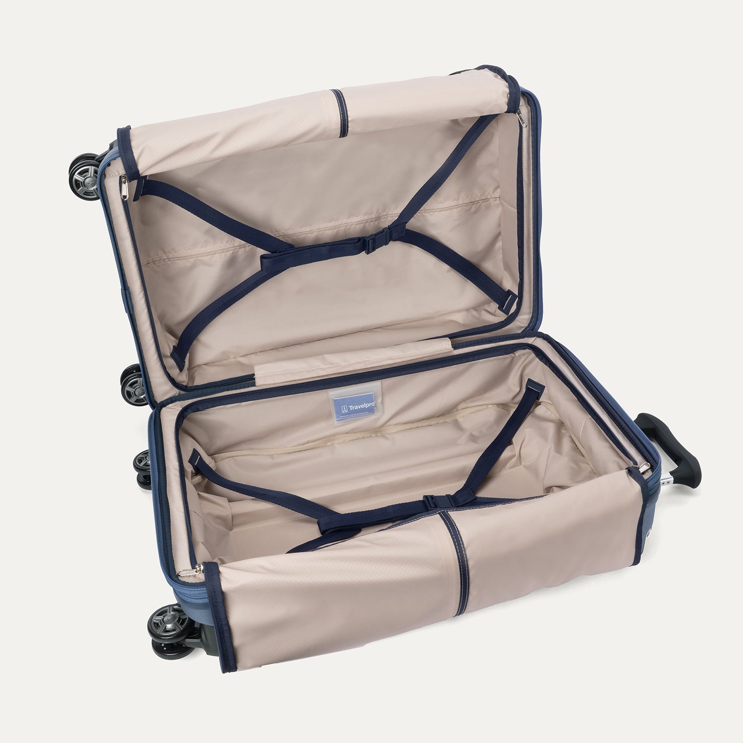 Interior view of the Travelpro Platinum Elite Medium Check-In Hardside Spinner in Dark Sky Blue, showing the adjustable hold-down straps and the spacious main compartment with ECOFAB™ lining.