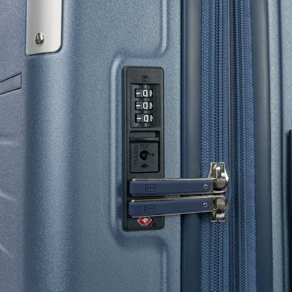 Close-up detail of the Travelpro Platinum Elite Medium Check-In Hardside Spinner in Dark Sky Blue, showing the integrated TSA-approved combination lock and secure zipper pulls on the polycarbonate shell.