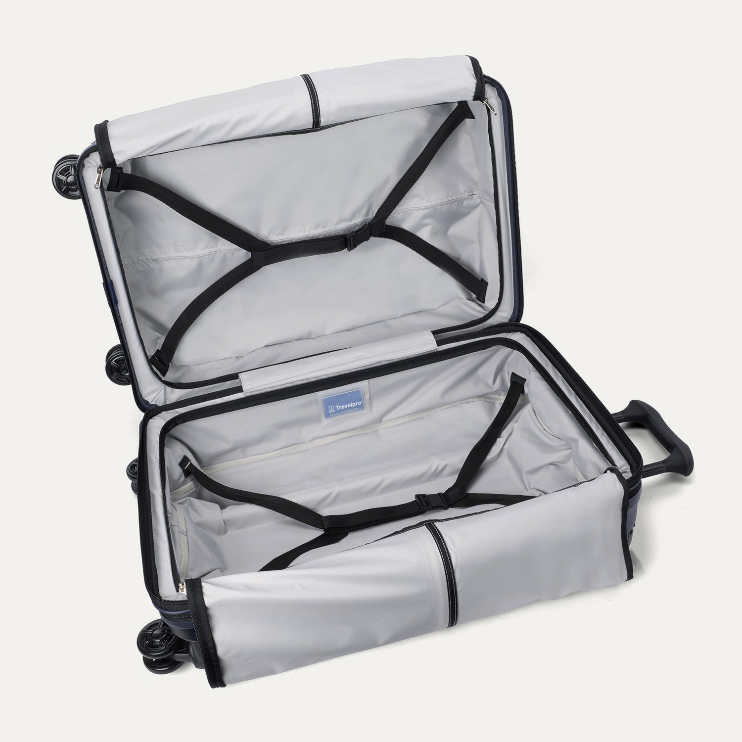 Open interior view of the Travelpro Platinum Elite Medium Check-In Hardside Spinner in Aviator Navy, showcasing the empty packing compartments, premium lining, and integrated tie-down straps.