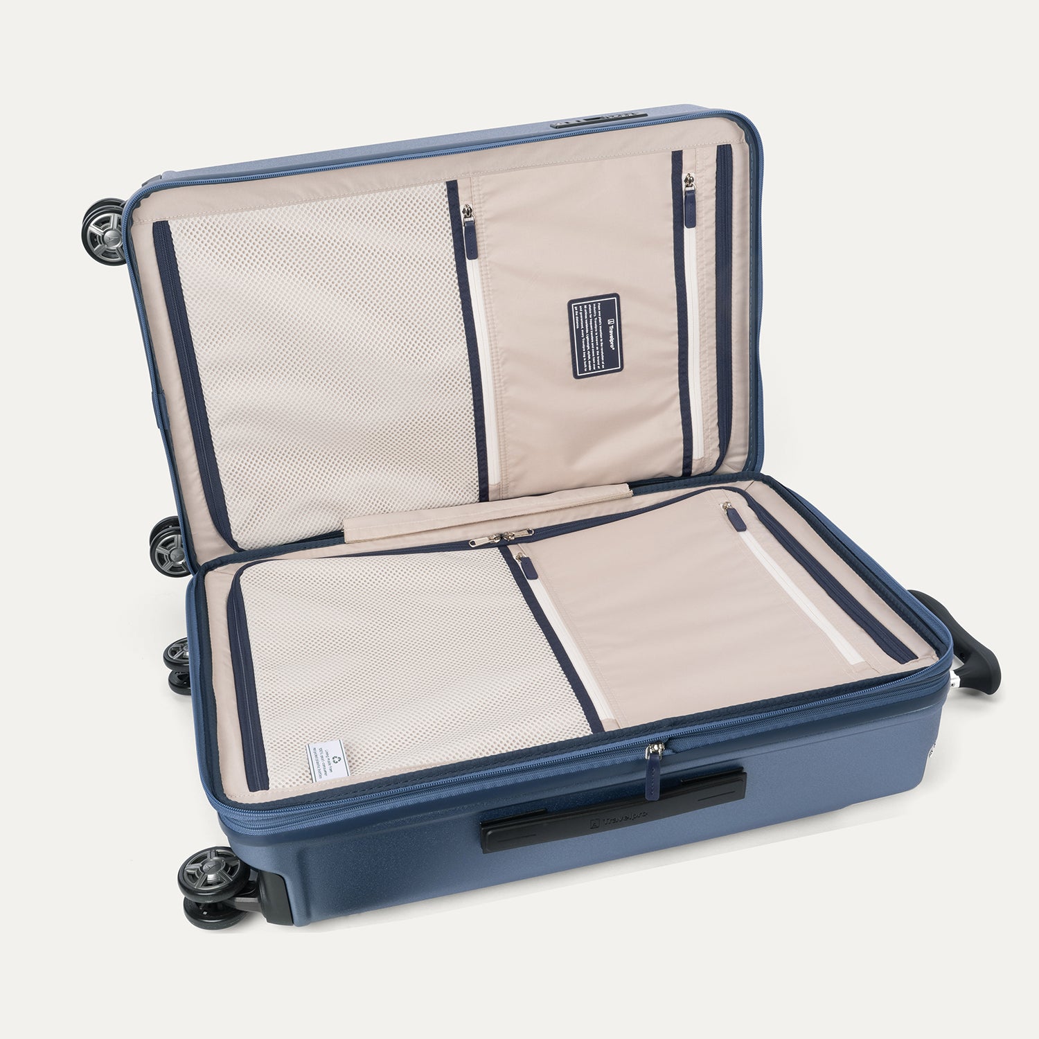Interior packing view of the Travelpro Platinum Elite Medium Check-In Hardside Spinner in Dark Sky Blue, featuring dual zippered divider panels, multiple accessory pockets, and a water-resistant pocket.